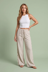 Pantaloni larghi beige con conchiglie
