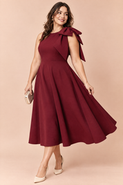 Robe midi bordeaux à encolure asymétrique et manche à nœud | Porté sur une silhouette plus ronde | Lounelle Paris