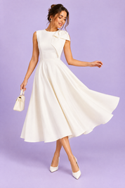 Robe midi blanche à encolure asymétrique et manche à nœud | Vue en mouvement | Lounelle Paris