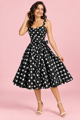 Abito corto nero a pois con linea svasata e scollo a cuore